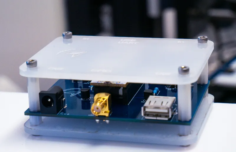 Small Cold reset electronic device with USB port, coaxial connector, and power input on a white surface.