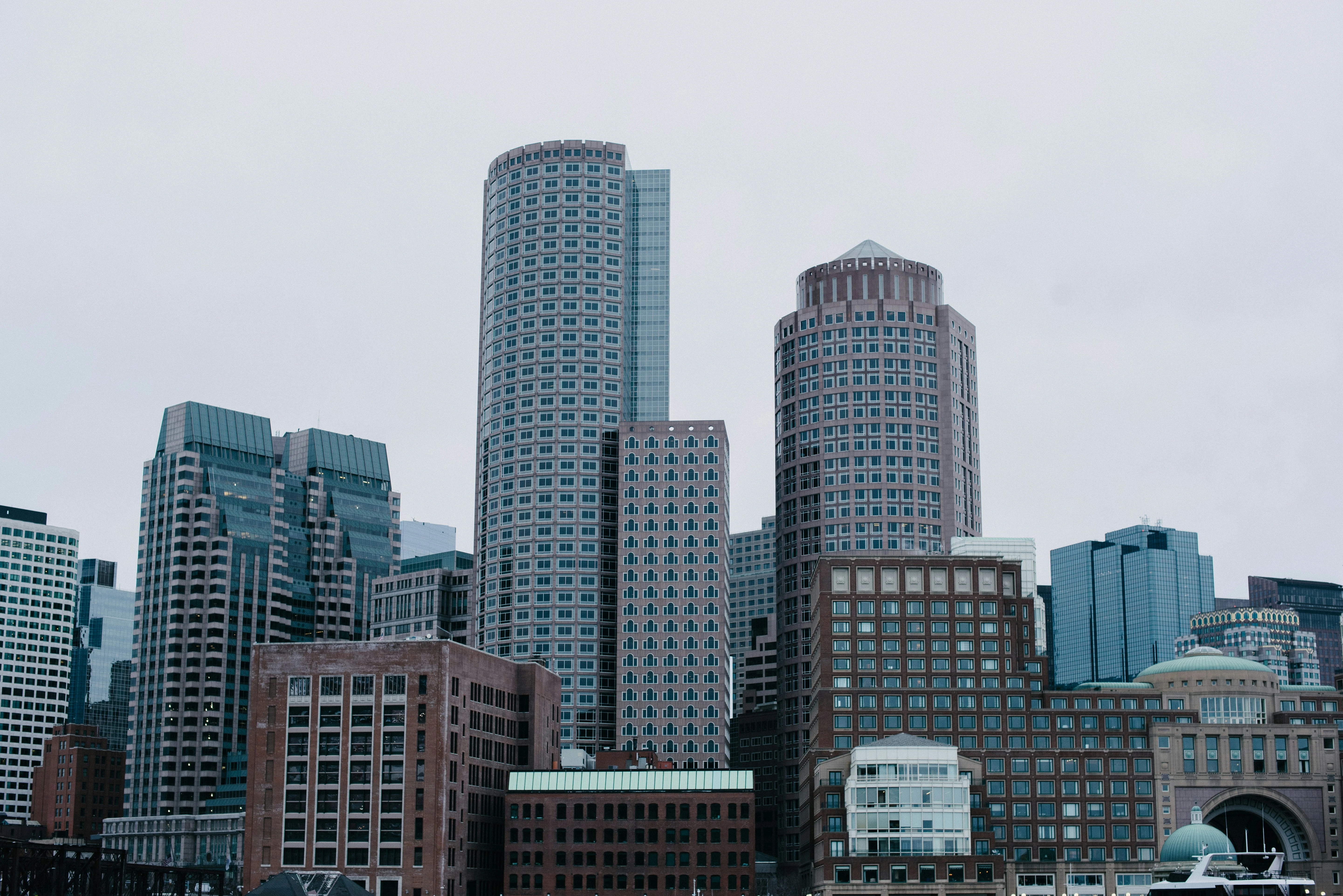 Skyline view of modern office buildings and skyscrapers under an overcast sky.
