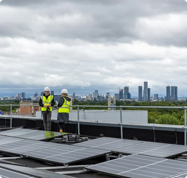 Engineers checking rooftop solar panels