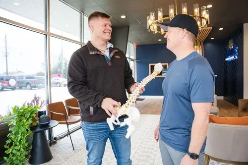 Chiropractor educating patient about spinal health and nervous system wellness