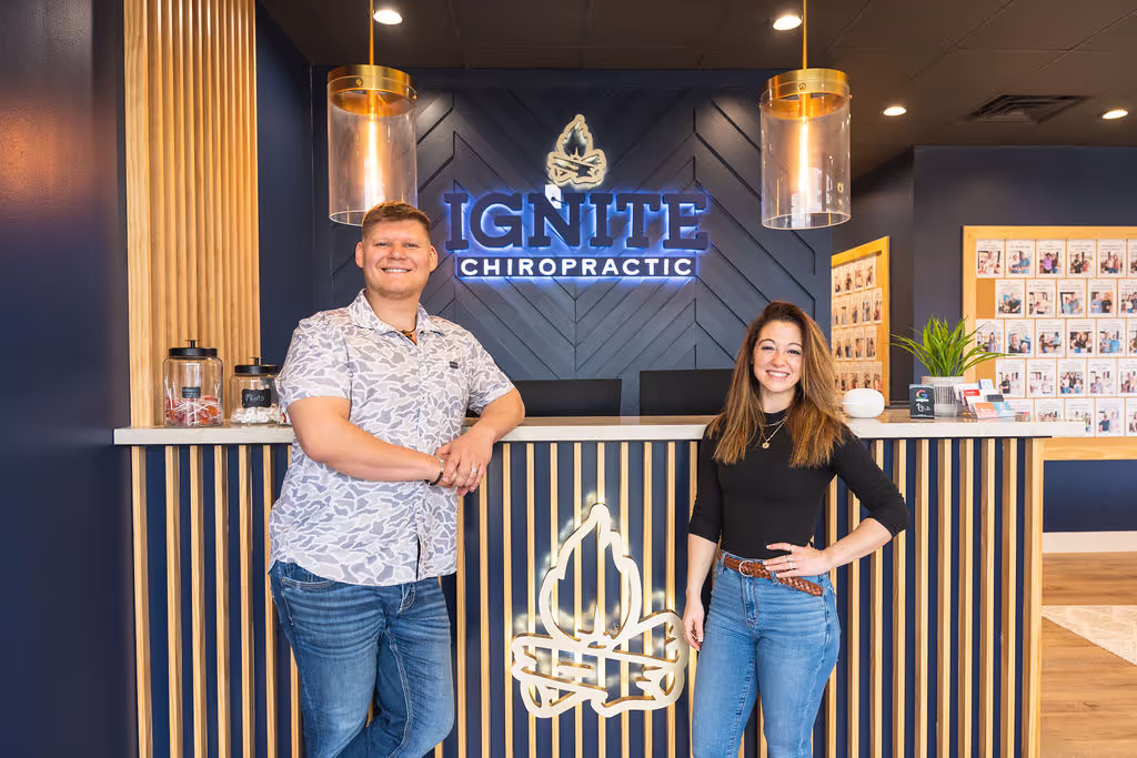 Ignite Chiropractic owners posing together in Cypress, TX office