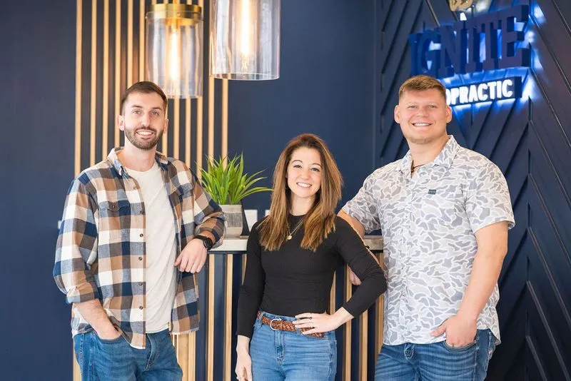 Ignite Chiropractic team smiling and posing together in office
