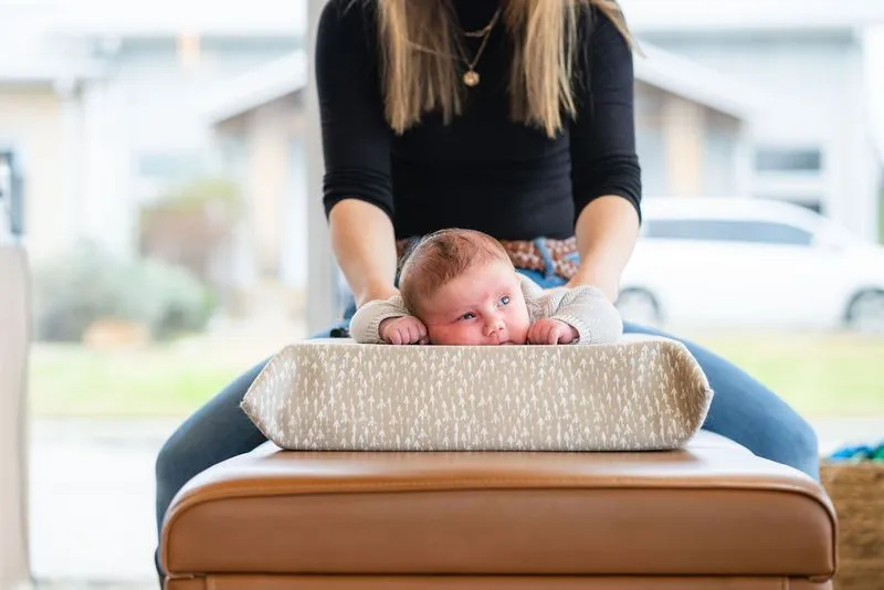 Baby receiving gentle adjustment from female pediatric chiropractor
