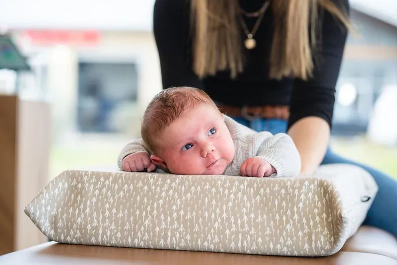 Baby receiving gentle spinal care from pediatric chiropractor in Cypress