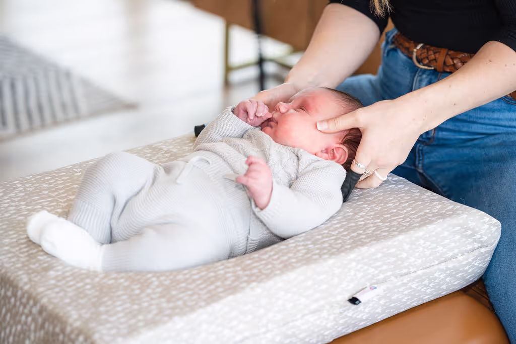 Infant receiving gentle pediatric chiropractic adjustment in Cypress, TX