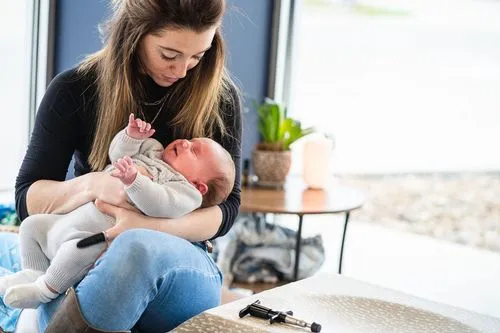 Pediatric chiropractor holding infant for gentle wellness adjustment