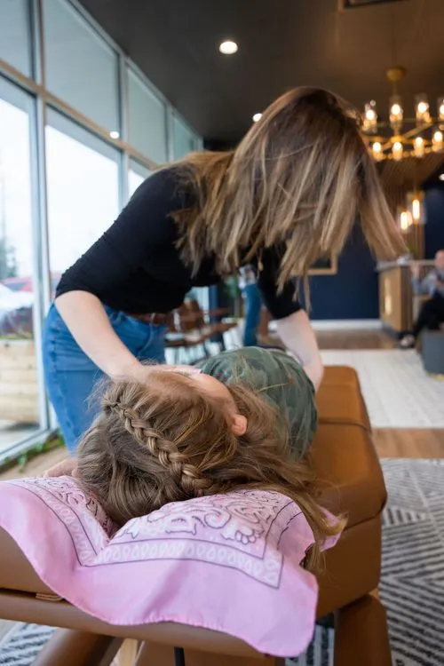 Young girl receiving gentle pediatric chiropractic adjustment from female chiropractor