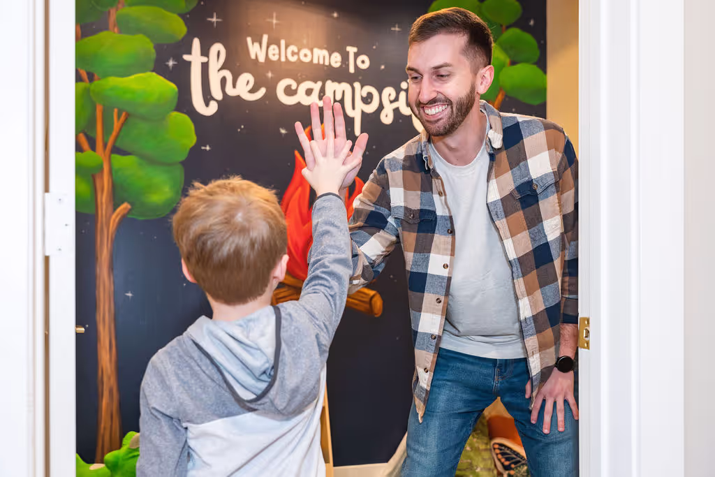 A chiropractic assistant at Ignite Chiropractic, helping a young child to support nervous system balance, improve sensory processing, and enhance overall well-being naturally for children with autism.