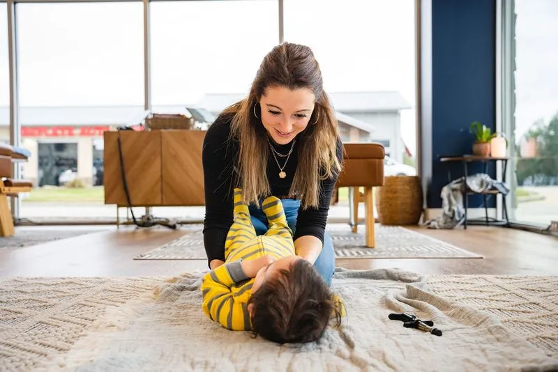 A chiropractor at Ignite Chiropractic gently adjusting a young child to support seizure management, brain health, and nervous system function naturally