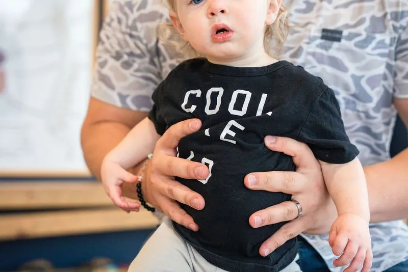 A chiropractor at Ignite Chiropractic gently adjusting a young child to support ear health, fluid drainage, and nervous system balance naturally.