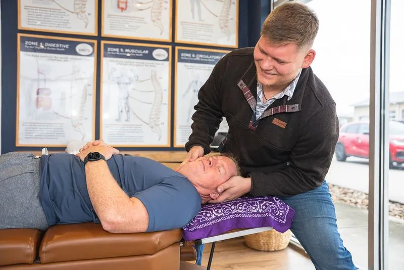 A chiropractor at Ignite Chiropractic performs a gentle upper cervical adjustment on a patient seeking natural migraine relief, addressing nervous system function and spinal alignment without medication.