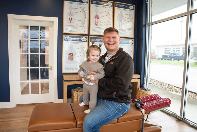 A chiropractor at Ignite Chiropractic gently adjusting a young child to support emotional regulation, nervous system balance, and overall well-being naturally.