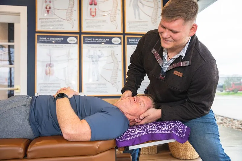 A chiropractor at Ignite Chiropractic gently adjusting a patient to support fatigue relief, nervous system function, and overall energy restoration naturally.