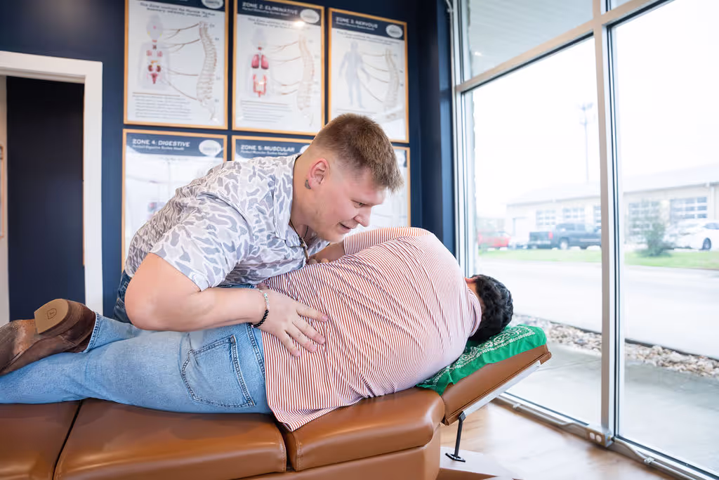 A chiropractor at Ignite Chiropractic gently adjusting a patient’s spine to support back pain relief, nervous system function, and overall mobility naturally.