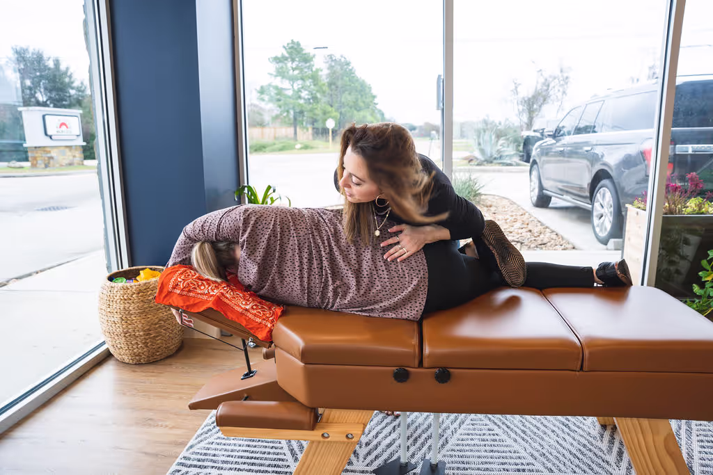 A chiropractor at Ignite Chiropractic, gently adjusting a patient’s spine to support sciatica relief, nervous system function, and overall mobility naturally
