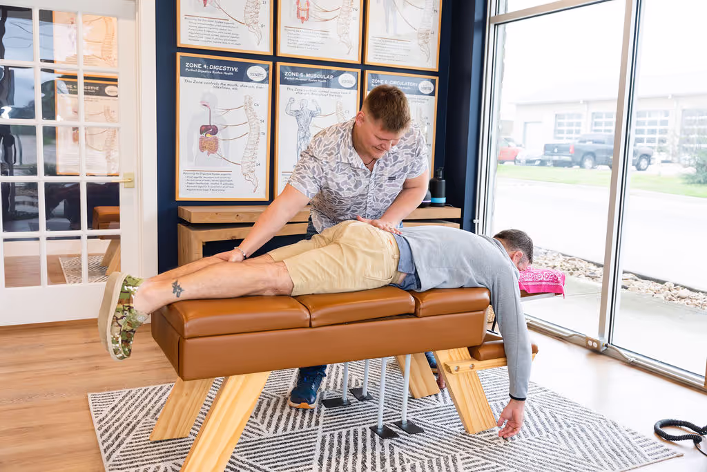 A chiropractor at Ignite Chiropractic near Tomball, TX adjusting a man to support his nervous system and overall health.
