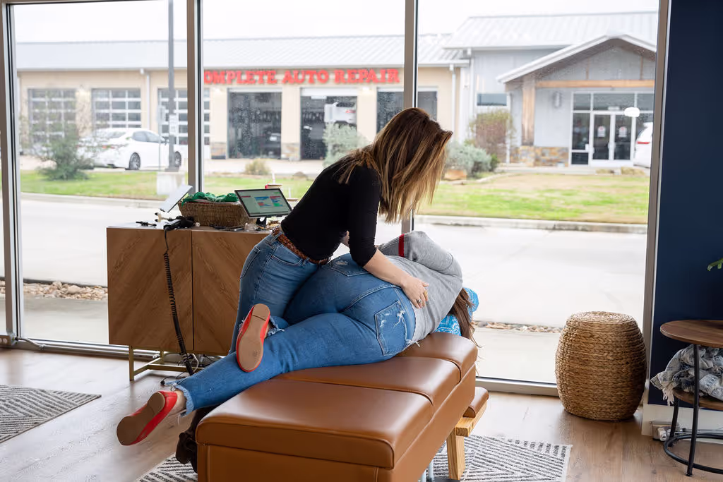 A chiropractor at Ignite Chiropractic gently adjusting a patient to support leg pain relief, improve mobility, and enhance overall nervous system function naturally.