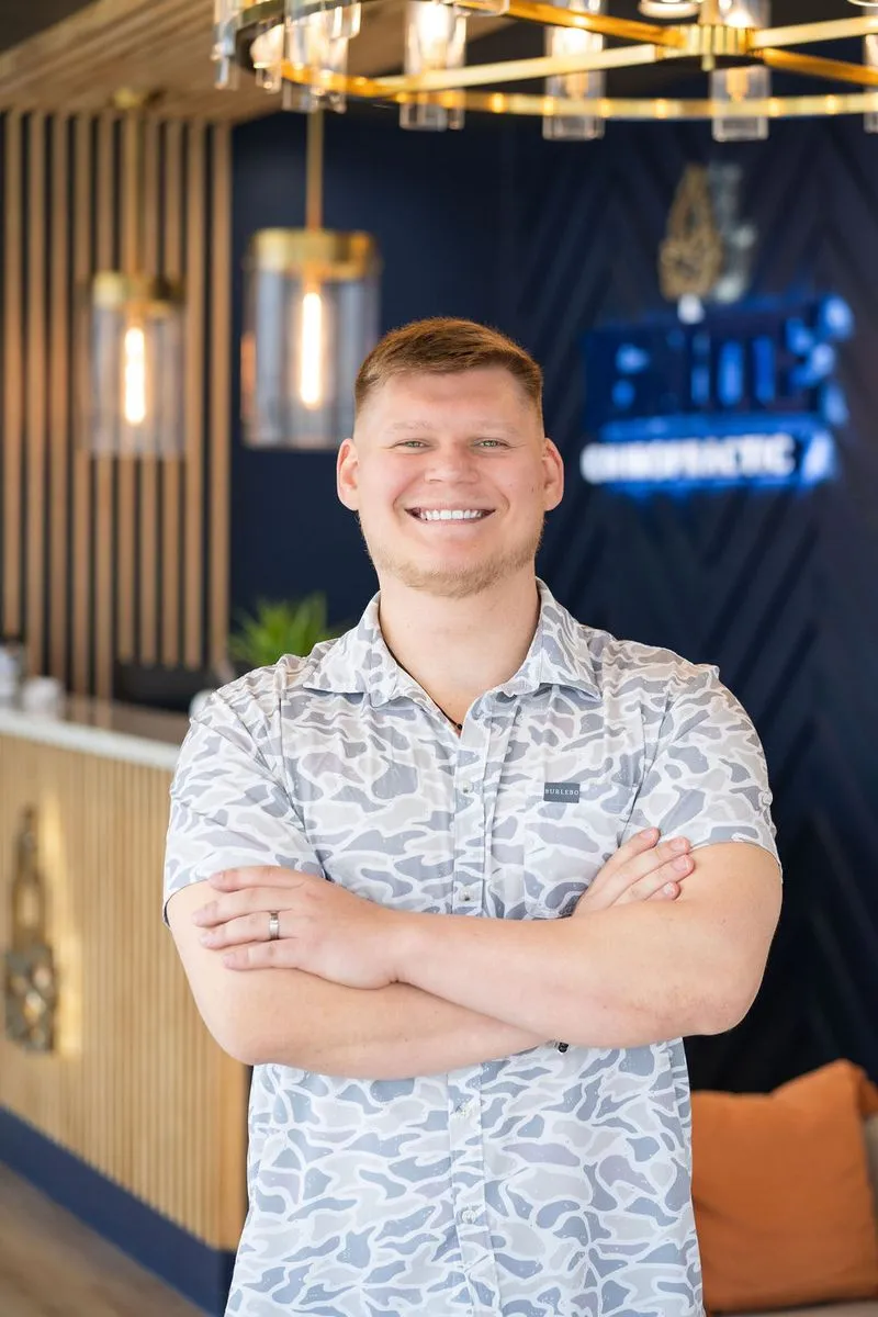 Dr. Derian Johnson standing in his office at Ignite Chiropractic in Cypress, TX.