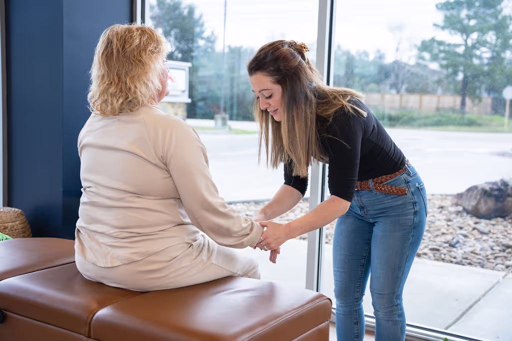 A chiropractor at Ignite Chiropractic, gently adjusting a patient to support carpal tunnel relief, improve wrist mobility, and enhance overall nervous system function naturally. 