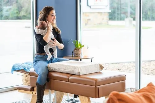 A chiropractor at Ignite Chiropractic gently adjusting a baby to support frequent crying relief, nervous system balance, and overall well-being naturally.