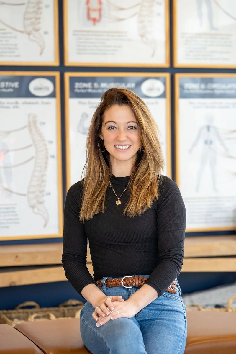Dr. Bethany Johnson from Ignite Chiropractic in Cypress, TX standing and smiling in her office.
