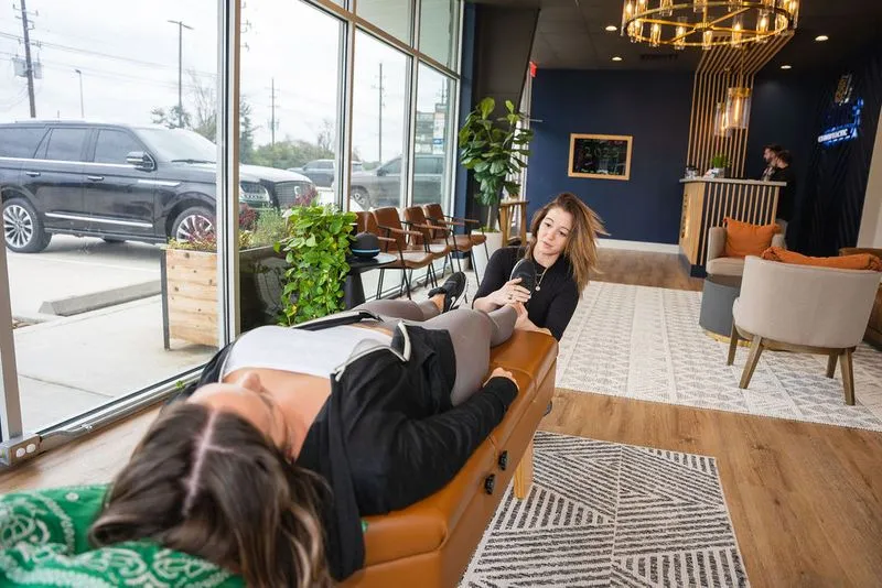 A chiropractor at Ignite Chiropractic in Cypress, TX performs a precise adjustment on a patient with tennis elbow, addressing both spinal alignment and extremity biomechanics to resolve underlying causes of overuse injuries naturally.