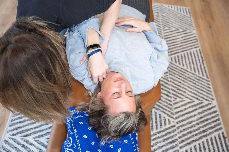 A chiropractor at Ignite Chiropractic, performs a gentle adjustment on a patient with shoulder bursitis, focusing on improving joint alignment, nervous system function, and natural movement patterns without medication.