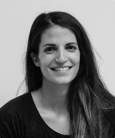 a girl with dark hair smiles