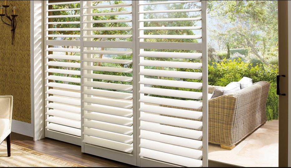 Bright, open plantation window shutters in Sparks, NV, showing an outdoor deck.