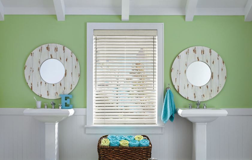 Green bathroom with double pedestal sinks and white window blinds for your Sparks, NV home.