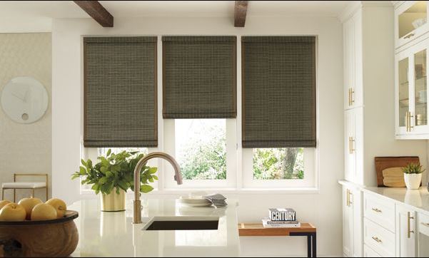 Three dark woven Reno, NV window shades installed over a sink in a bright white kitchen.