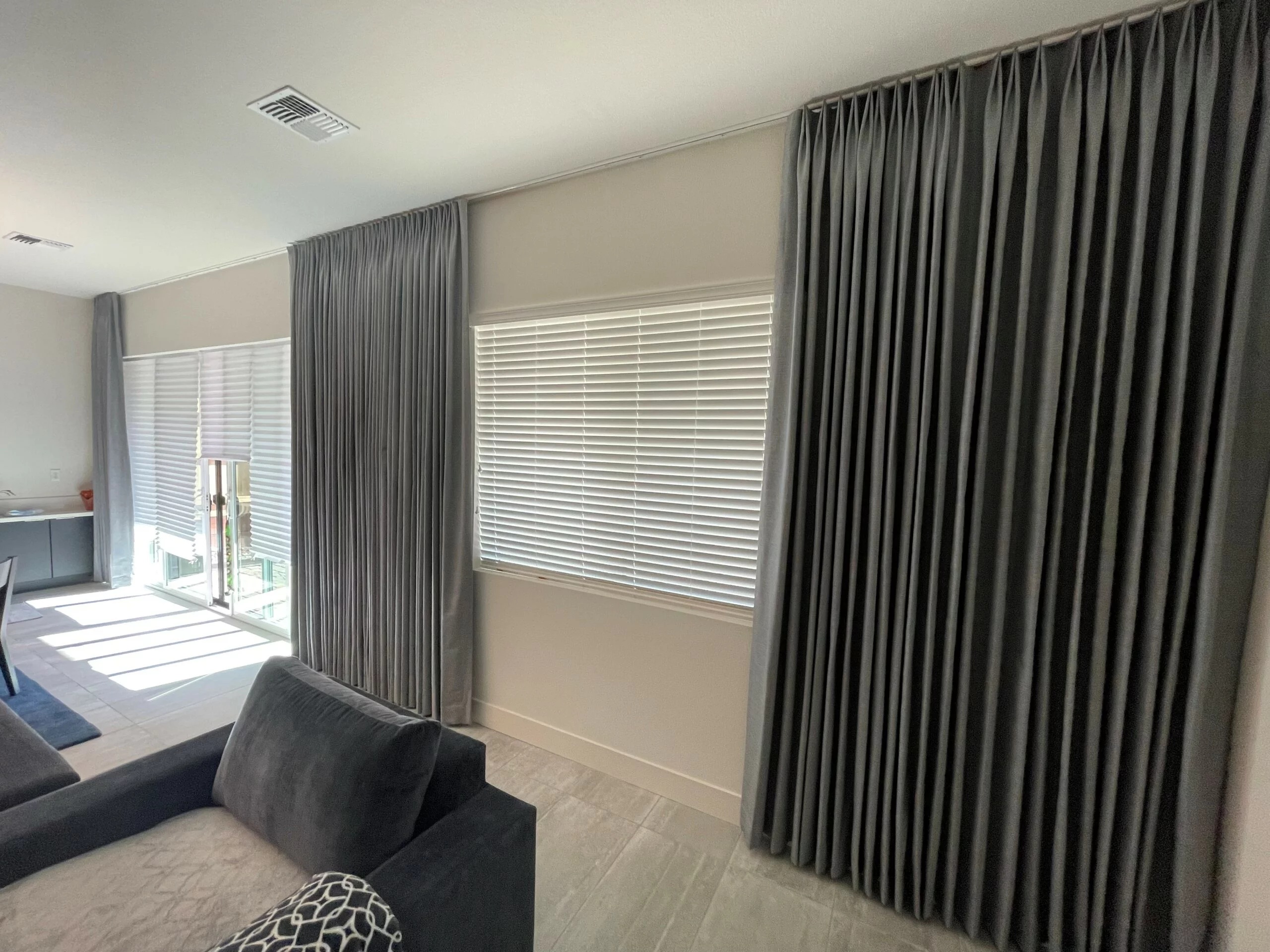 Truckee, CA window blinds with gray drapery in a modern living room