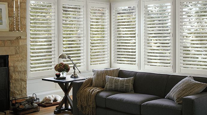 Living room featuring window shutters in Truckee, CA with plantation panels.