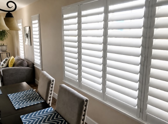 Dining room featuring window shutters in Reno, NV with filtered daylight.