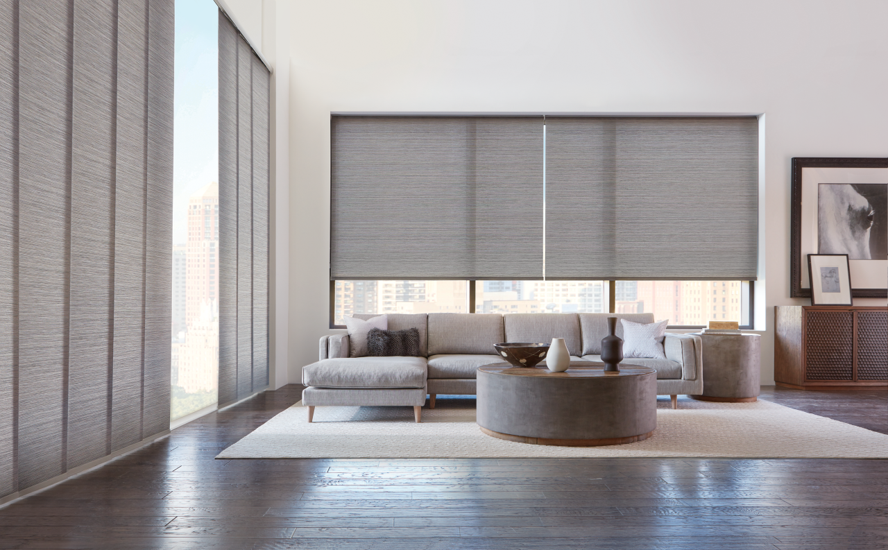 Motorized window shades operated by remote in a modern living room