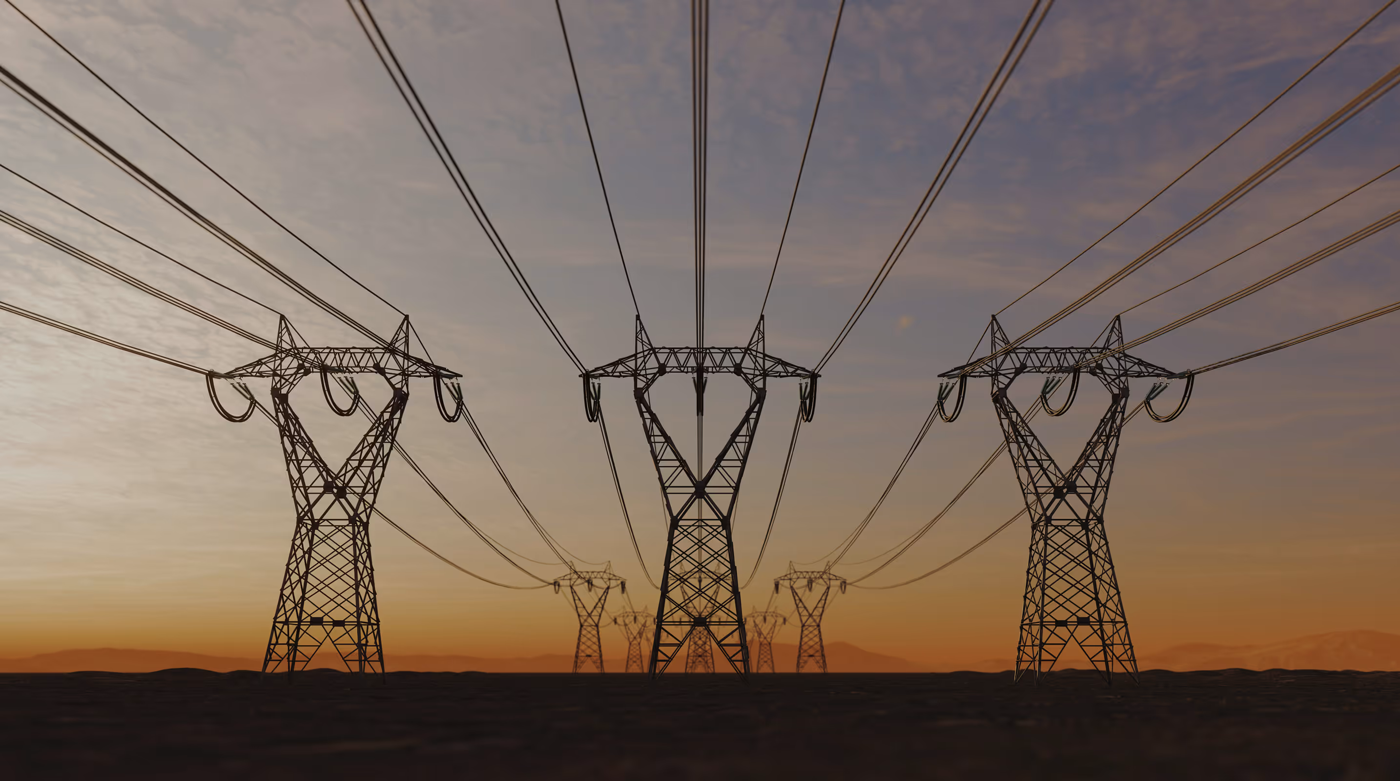 Silhouettes of electrical transmission towers and power lines against a sunset sky.