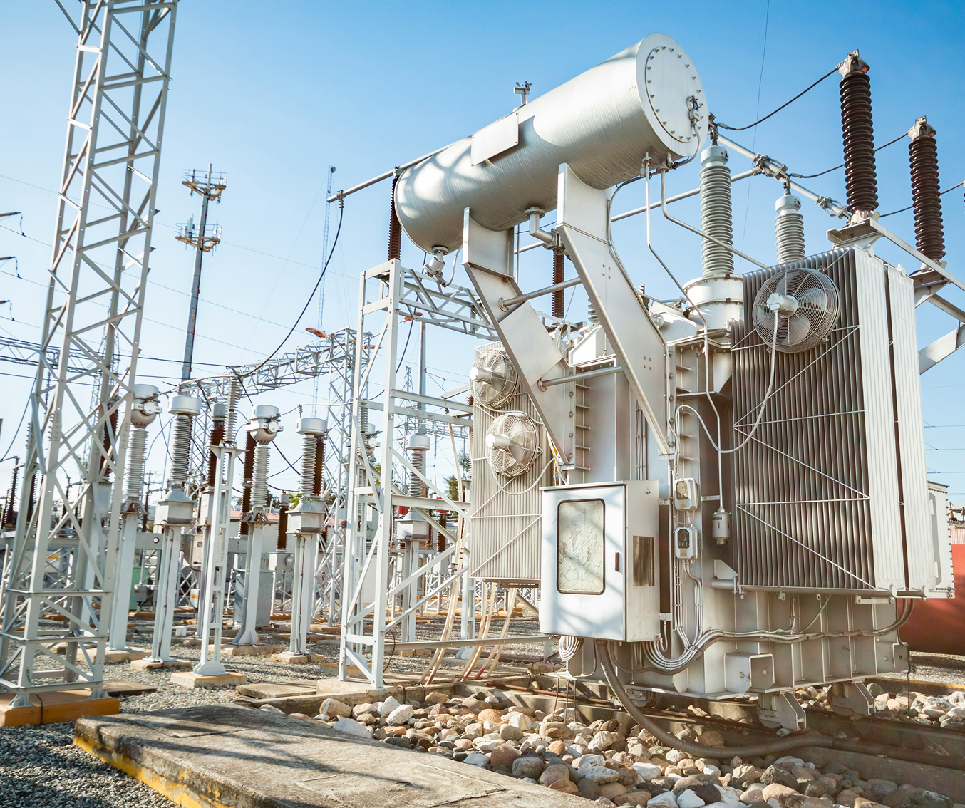 Large electrical transformer and power lines at an outdoor electrical substation.