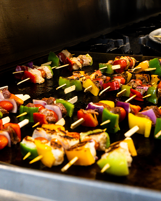 Authentic flame-grilled chicken and steak kabob skewers served with aromatic rice and fresh Mediterranean salad at Sofra Taverna Las Vegas.