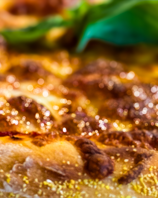 Thin crust pepperoni pizza with melted mozzarella and fresh herbs