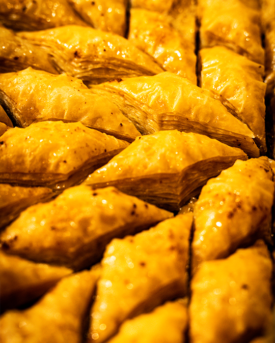 Handmade honey-drizzled pistachio baklava pastries at Sofra Taverna