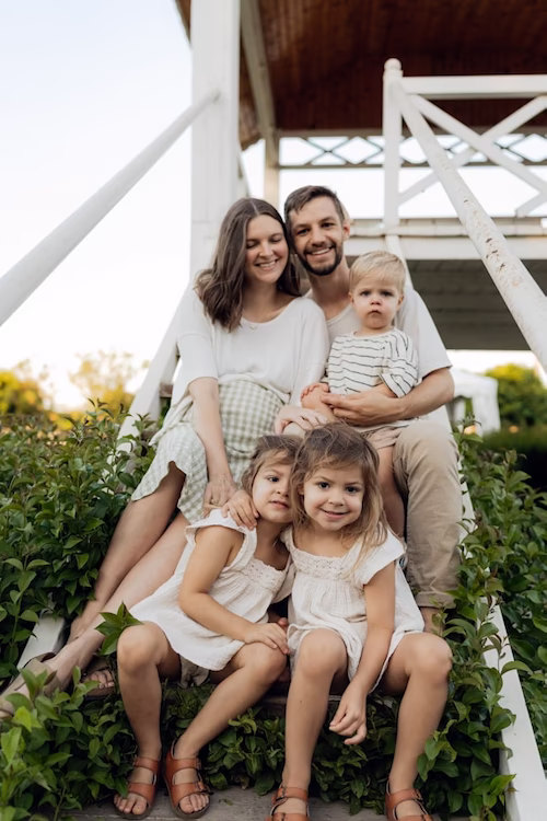 family sitting on stairs