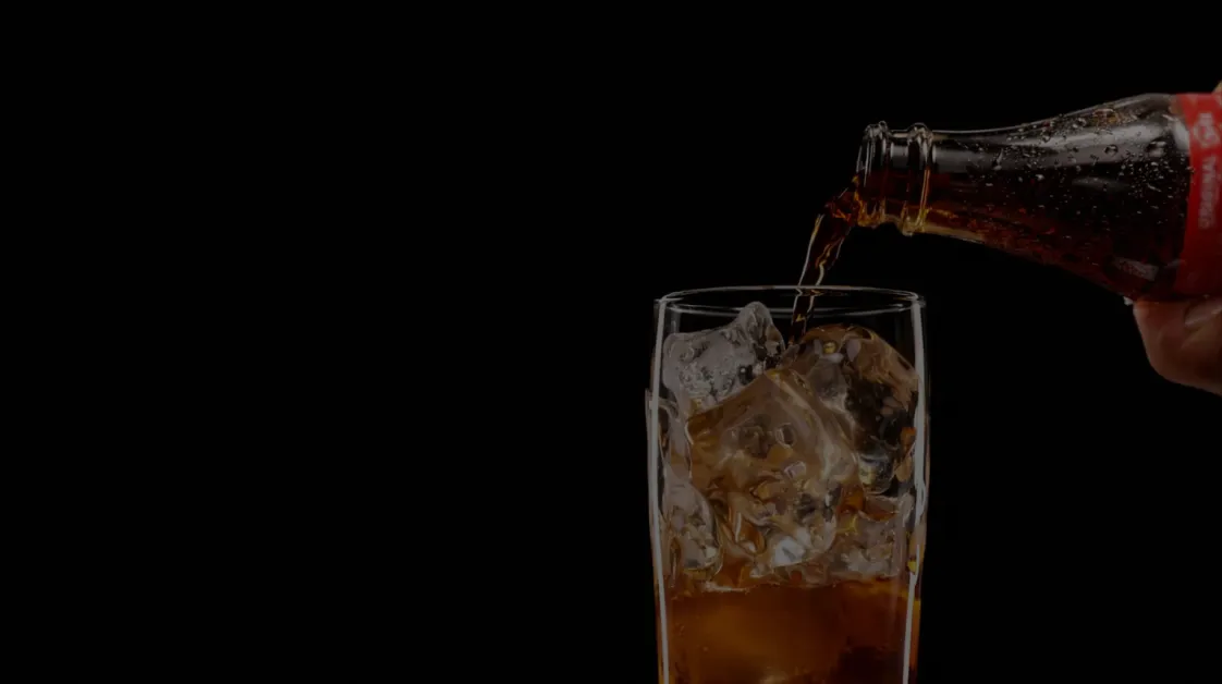 Drink being poured into an iced glass