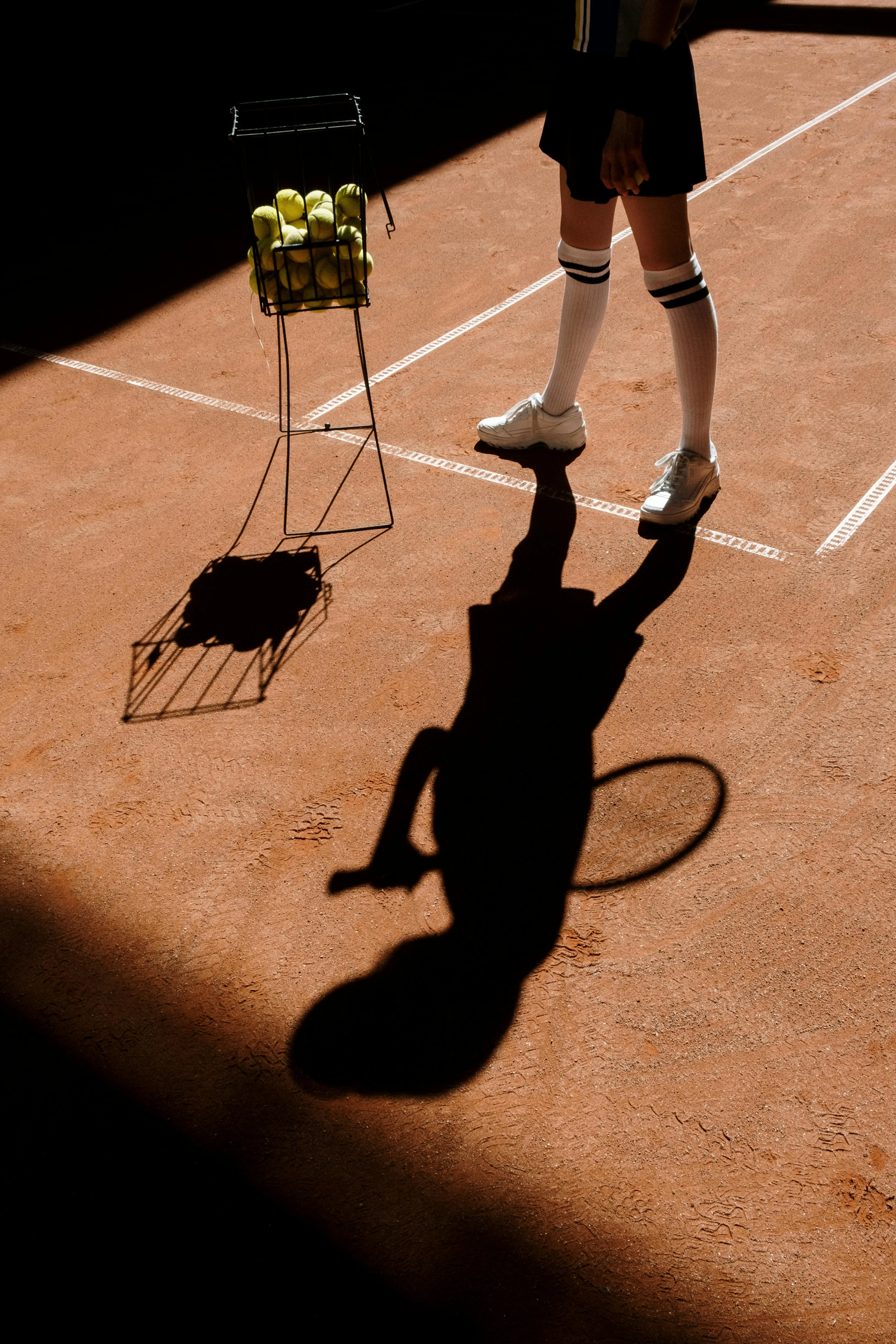 Man Standing next on Padel Ball Rack