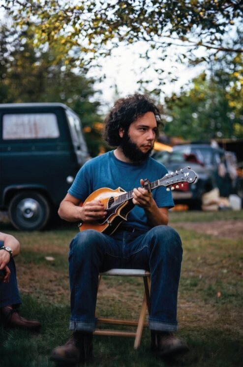 Laskin playing mandolin in 1975
