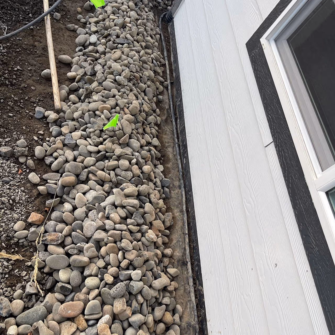 Landscape river rock installation by Two Rivers Lawn Care & Landscaping in Lewiston, Idaho and Clarkston, Washington