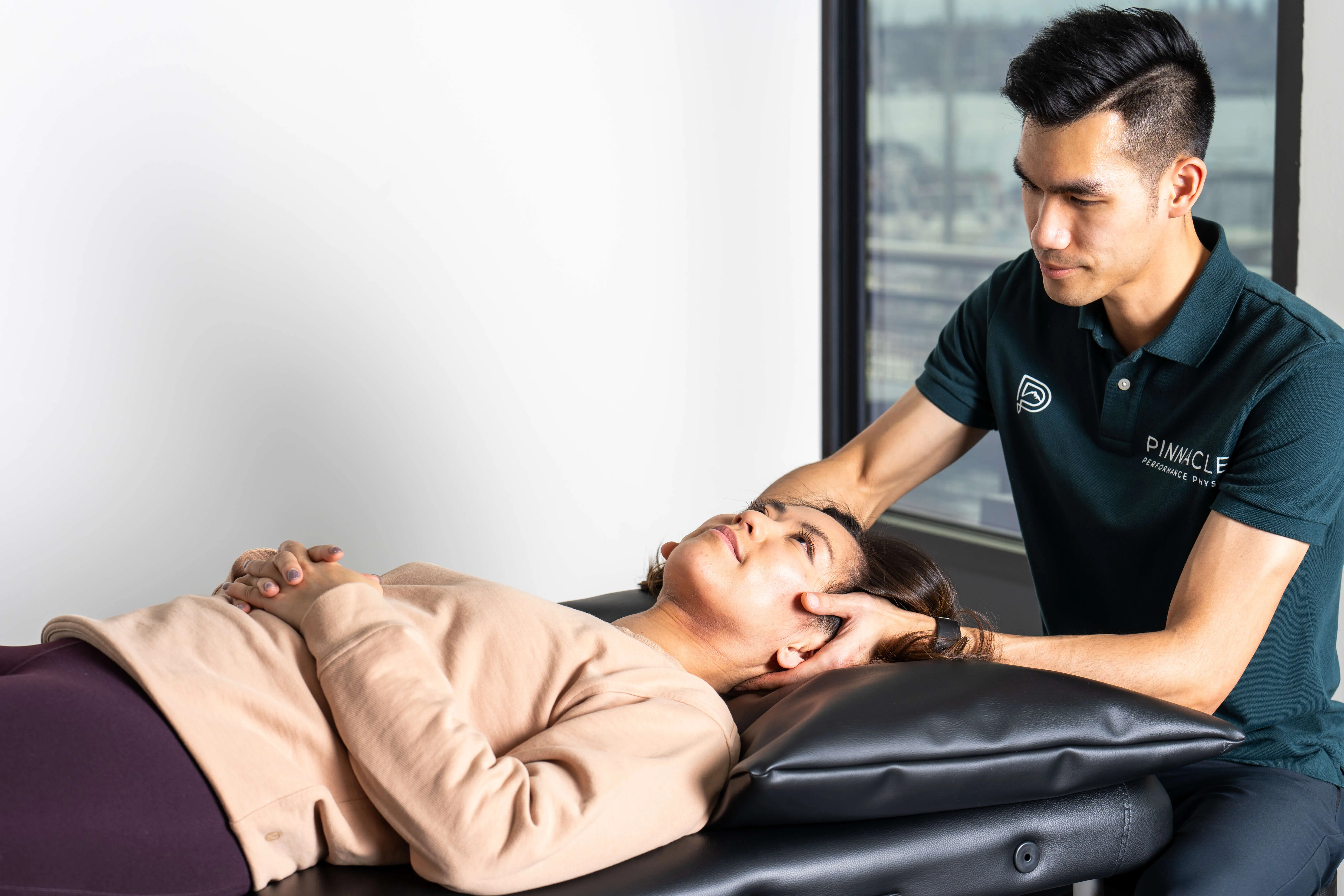 physical therapist treating badminton athlete in Bellevue clinic