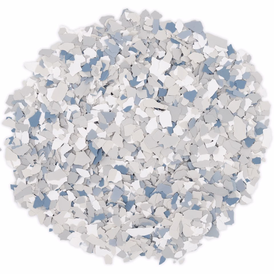 Pile of small decorative floor flakes in shades of white, gray, and blue.