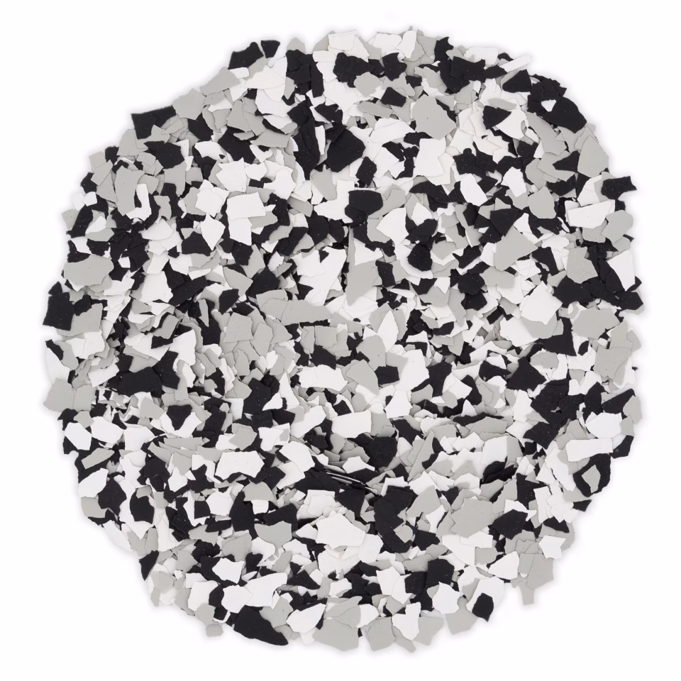 Pile of small, irregular chips in black, white, and gray colors.