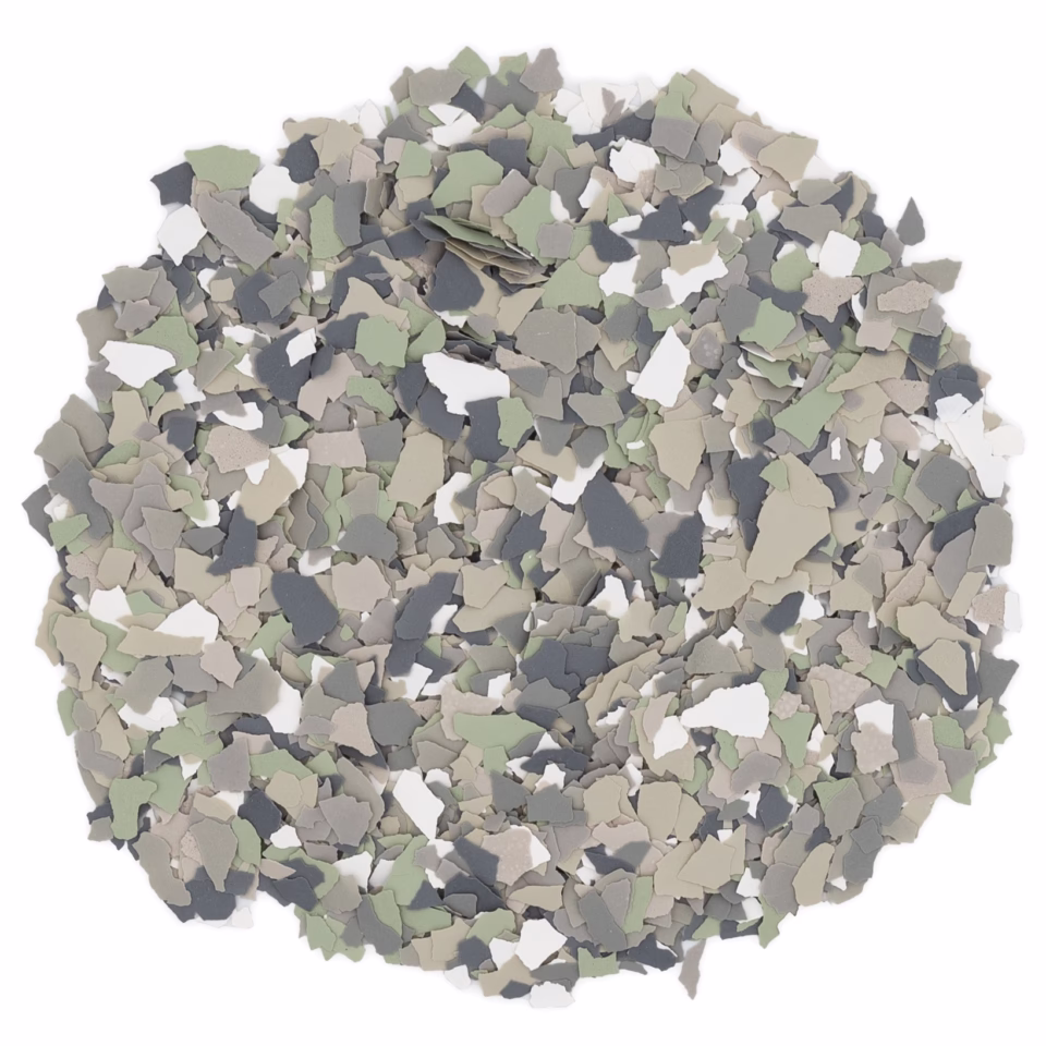 Pile of dried thyme leaves in mixed shades of green, beige, gray, and white on a white background.