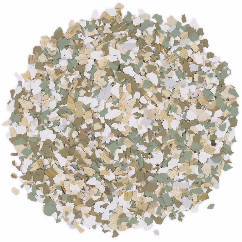 Close-up of a circular pile of multi-colored flakes in shades of green, beige, white, and light gray.